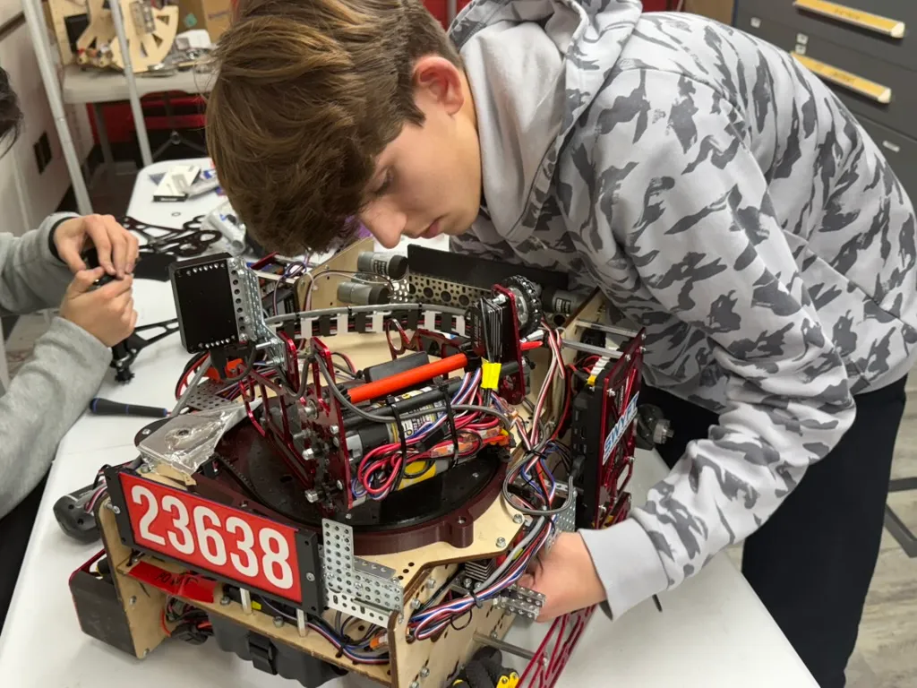 Student wiring and assembling FTC robot 23638