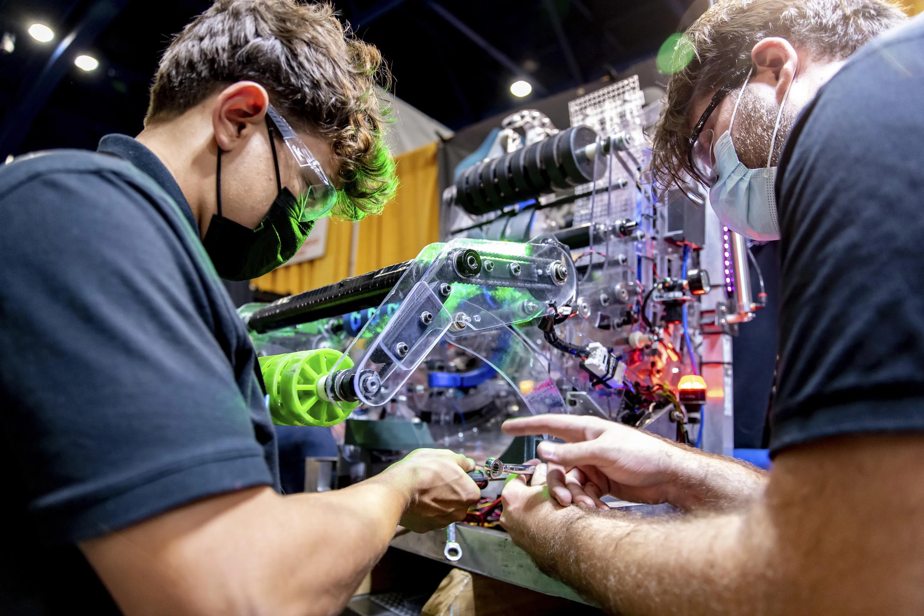 Students working on an FRC robot in the pit